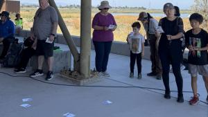 Participants in Saved By Nature's bird activity admire illustrations of Bay Area birds