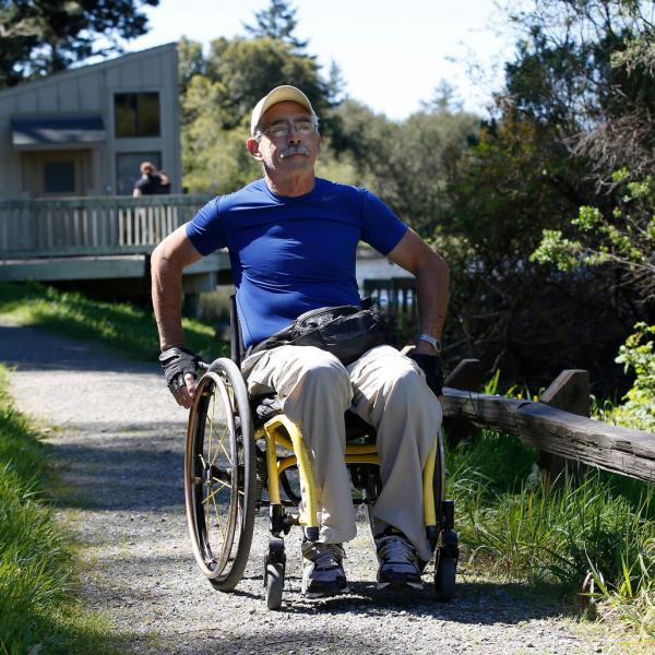 a man in a wheelchair on a trail