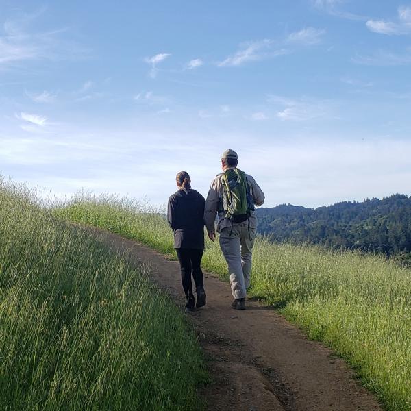 two people hiking on a trail
